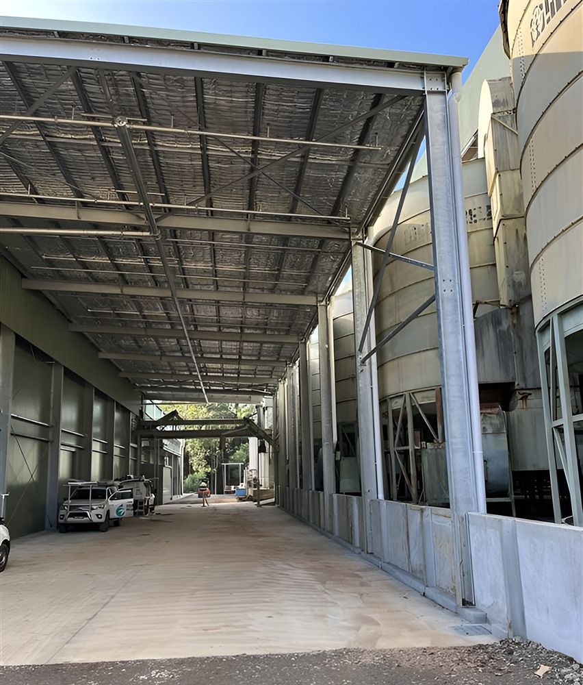 A Wide Outdoor Industrial Area Featuring A Metal-Roofed Canopy — Roof Repairs Coffs Harbour -Coastal Plumbing Group in Woolgoolga, NSW
