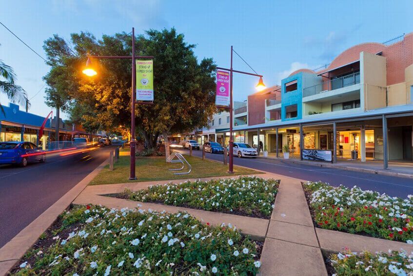 A Close Up Of A Rusty Pipe In A Field With Trees In The Background — Coastal Plumbing Group in Woolgoolga, NSW