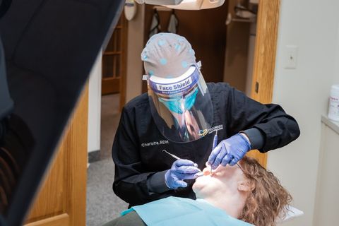 Dental Hygienist examining patients teeth at Tecumseh Family Dental Care
