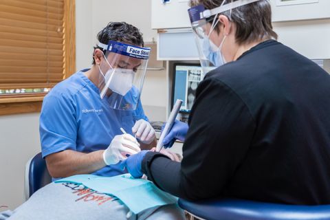 Dr. Hourani and Dental Hygienist looking at patient's x-rays at Tecumseh Family Dental Care