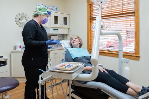 Dental Hygienist talking to patient in exam chair at Tecumseh Family Dental Care