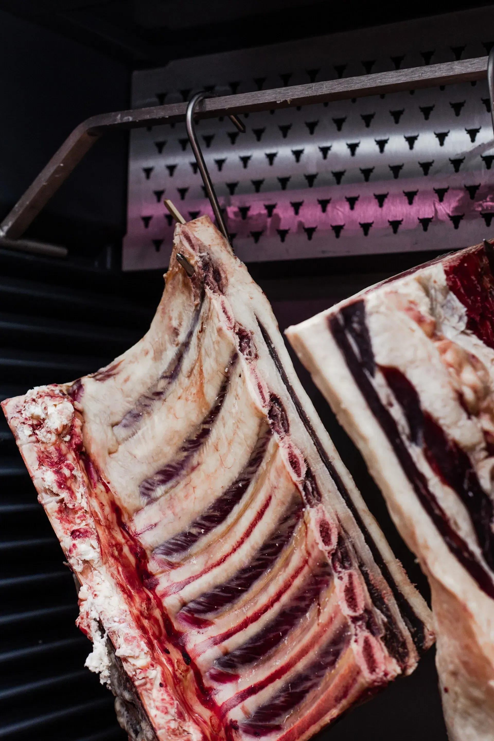 Ribs of Beef Hanging on a Hook, Showing Raw Meat and Bone  — Lighthouse Meat & Poultry In Port Macquarie, NSW
