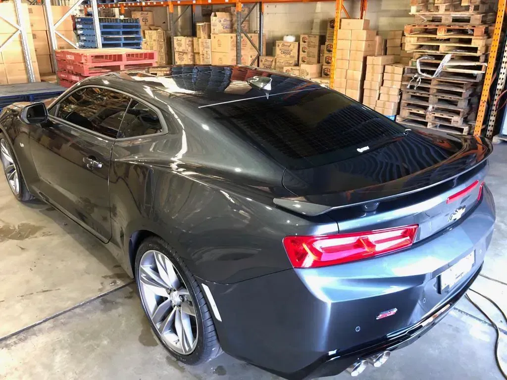 a car using Pro-Tec's mobile window tinting service in the garage.