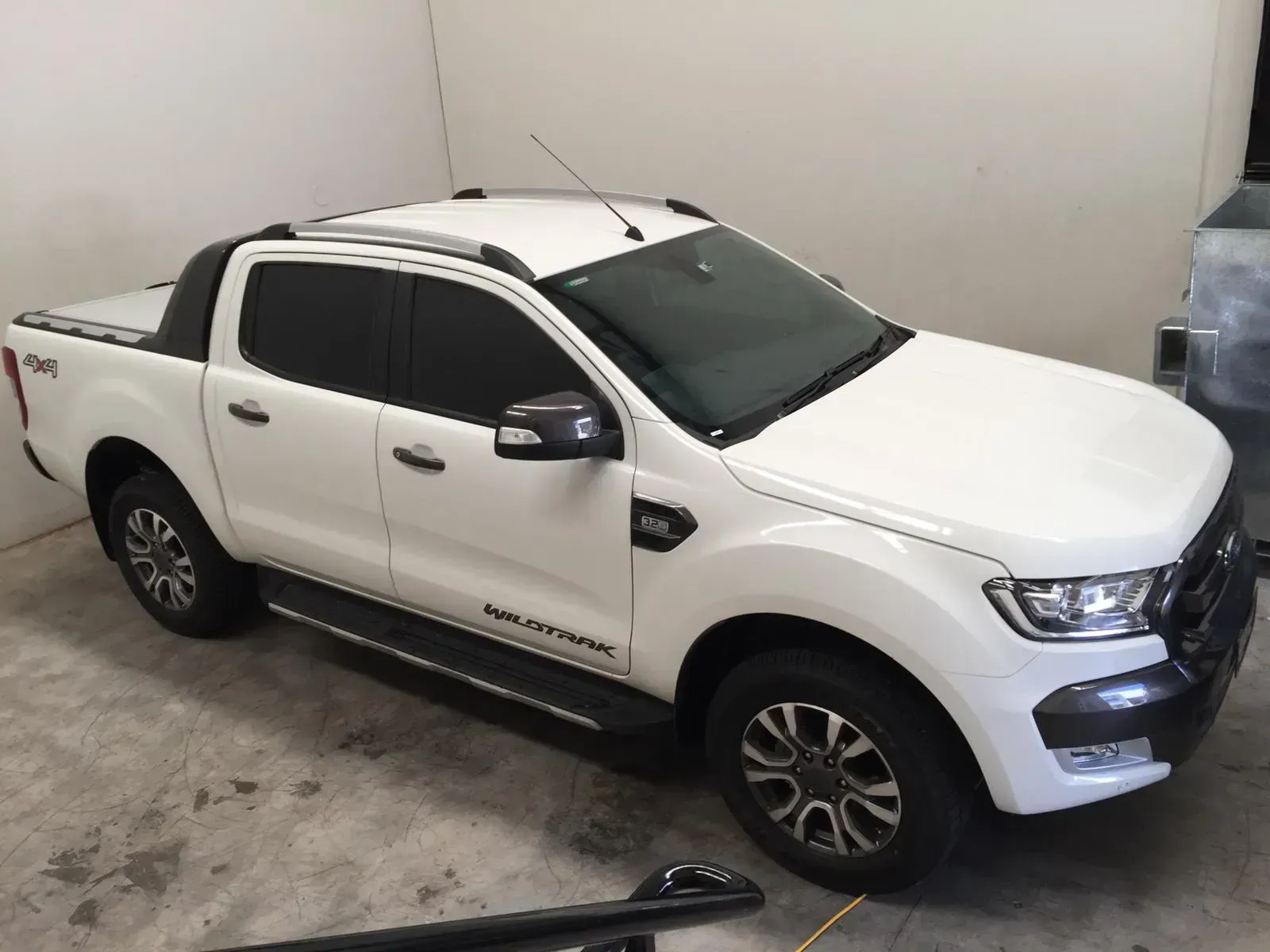 A white ute is parked in a garage after an installation of UV protection window films in Rouse Hill.