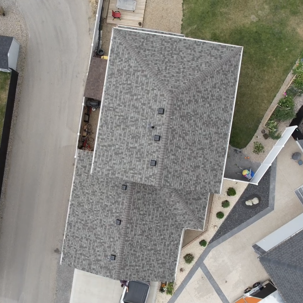 an aerial view of a house with a gray roof .