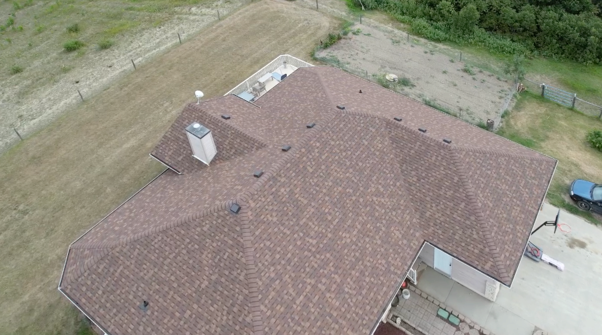 an aerial view of a house with a roof that is being installed .