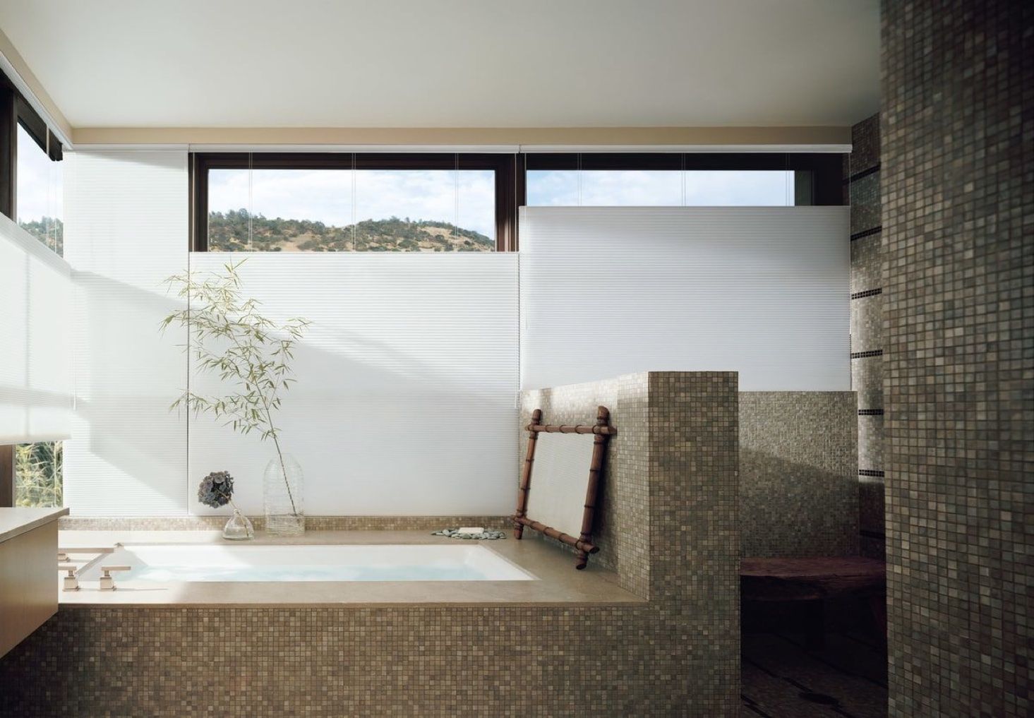 honeycomb cell shades with top down bottom up in bathroom over tub.