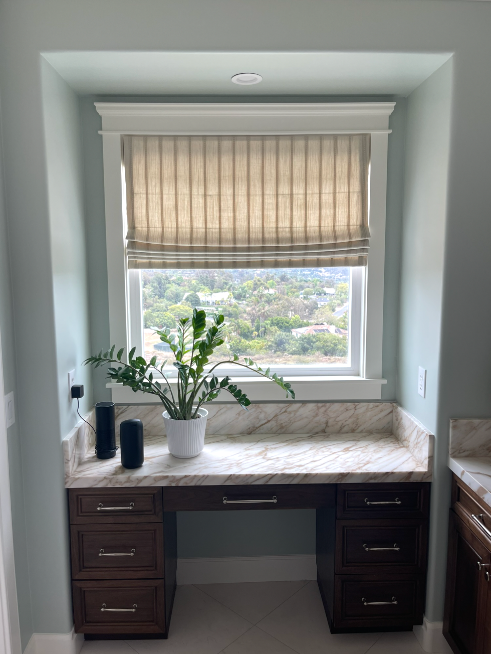 flat roman shade with designer striped fabric by window spaces in carlsbad, ca