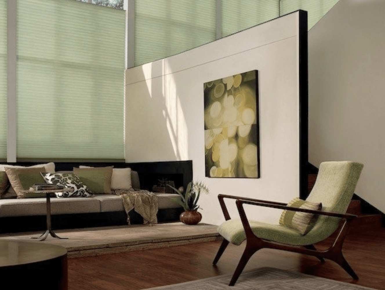 Muted green window shades and home accents create a peaceful feeling in this living room.