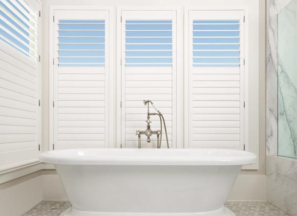 White Plantation Shutters with Split Tilt - Window Spaces , Carlsbad, CA  in bathroom window