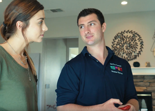 Consultant and customer reviewing Hunter Douglas Powerview Motorized Shades.