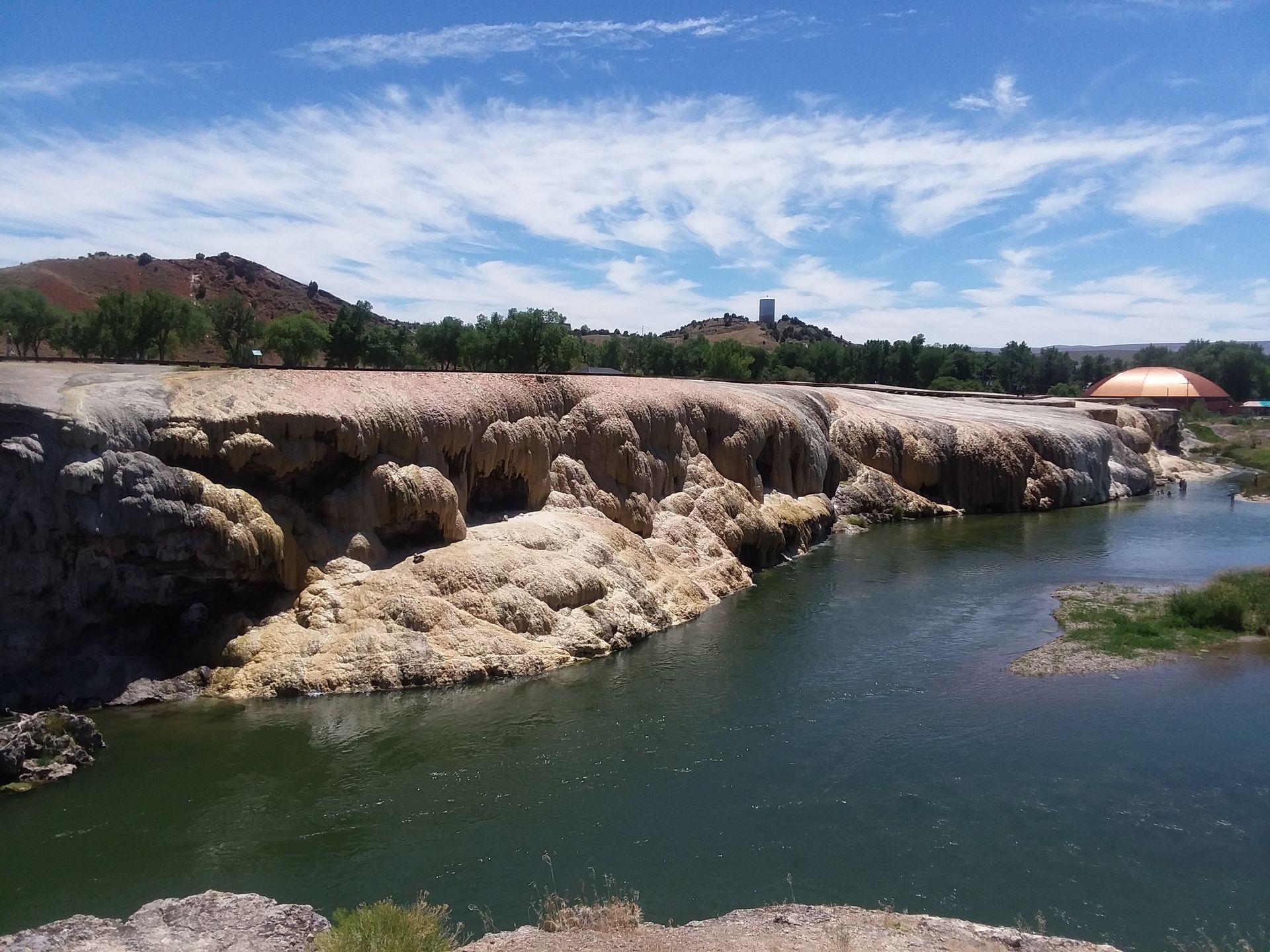 A large body of water surrounded by rocks and trees