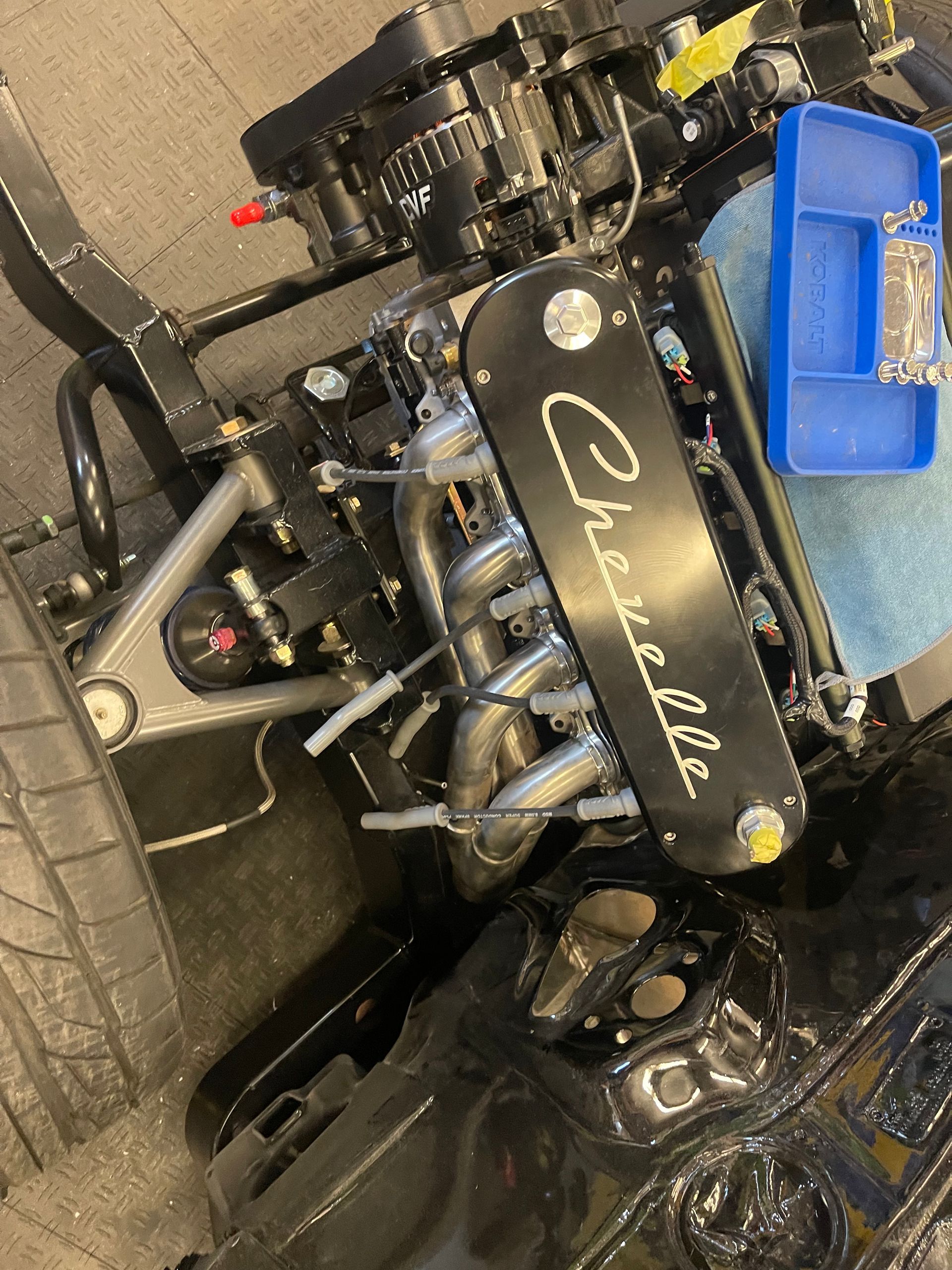 A high-angle view of a custom car engine with a black 