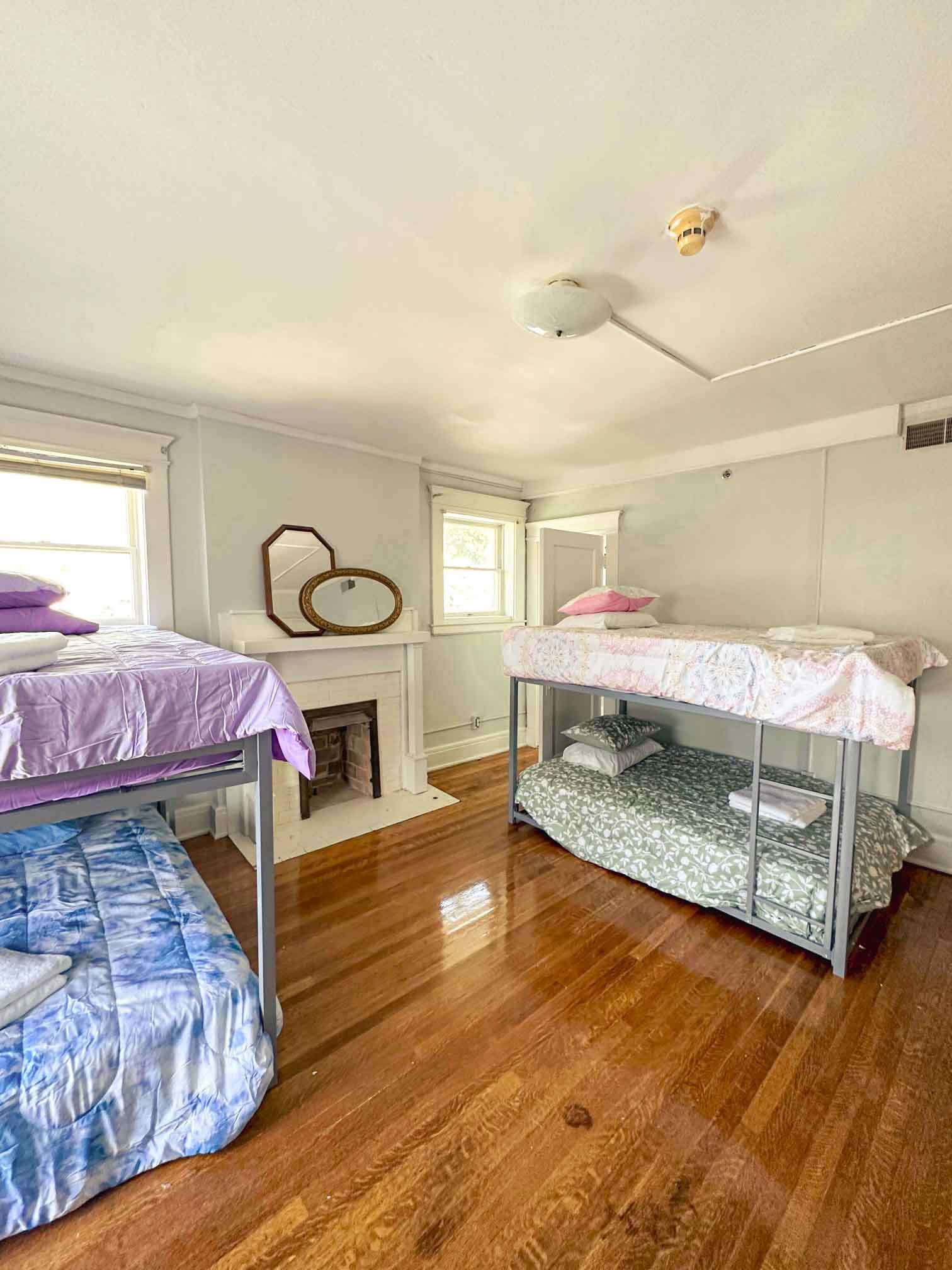 A bedroom with two bunk beds and a fireplace.