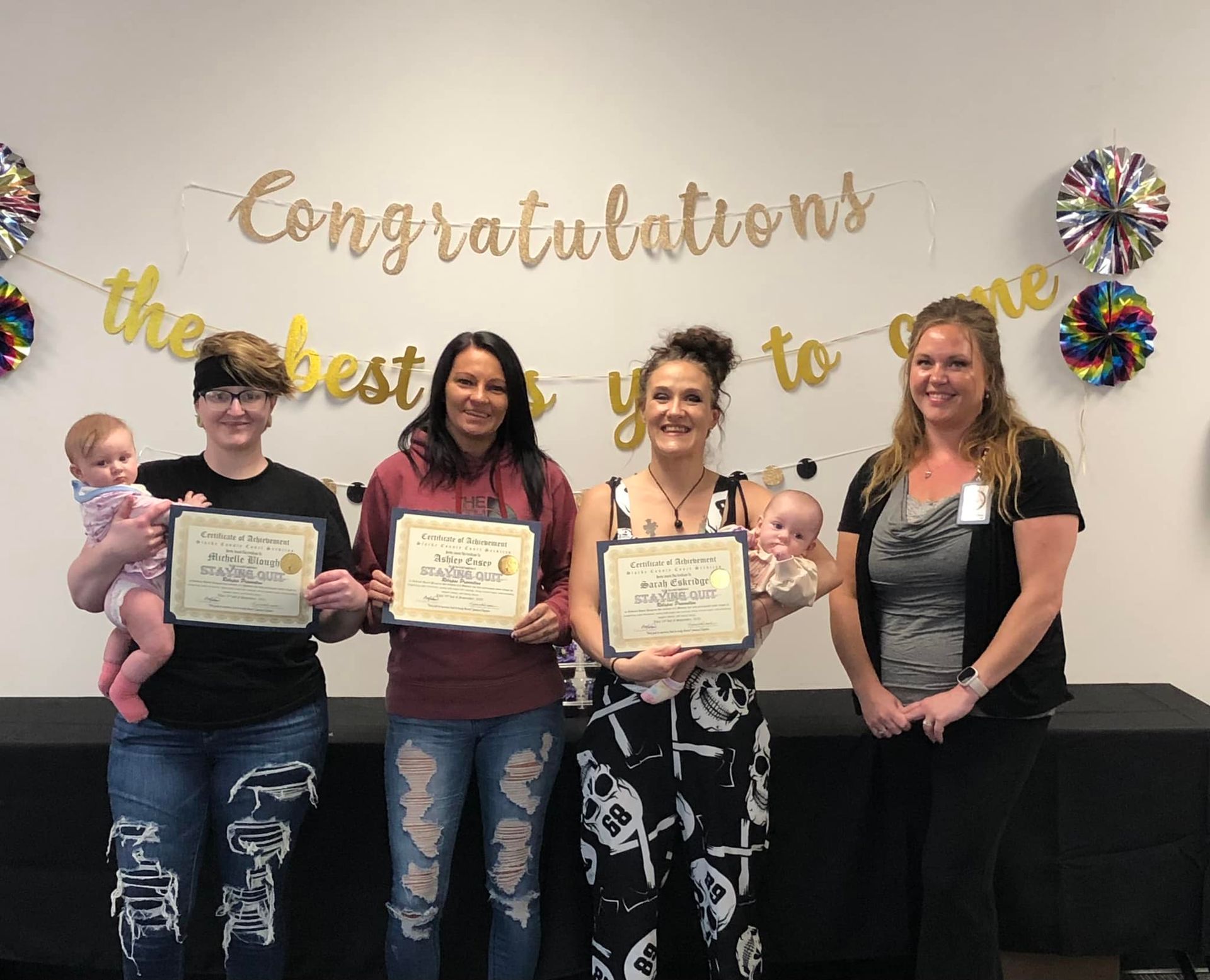 A group of women are standing next to each other holding certificates.