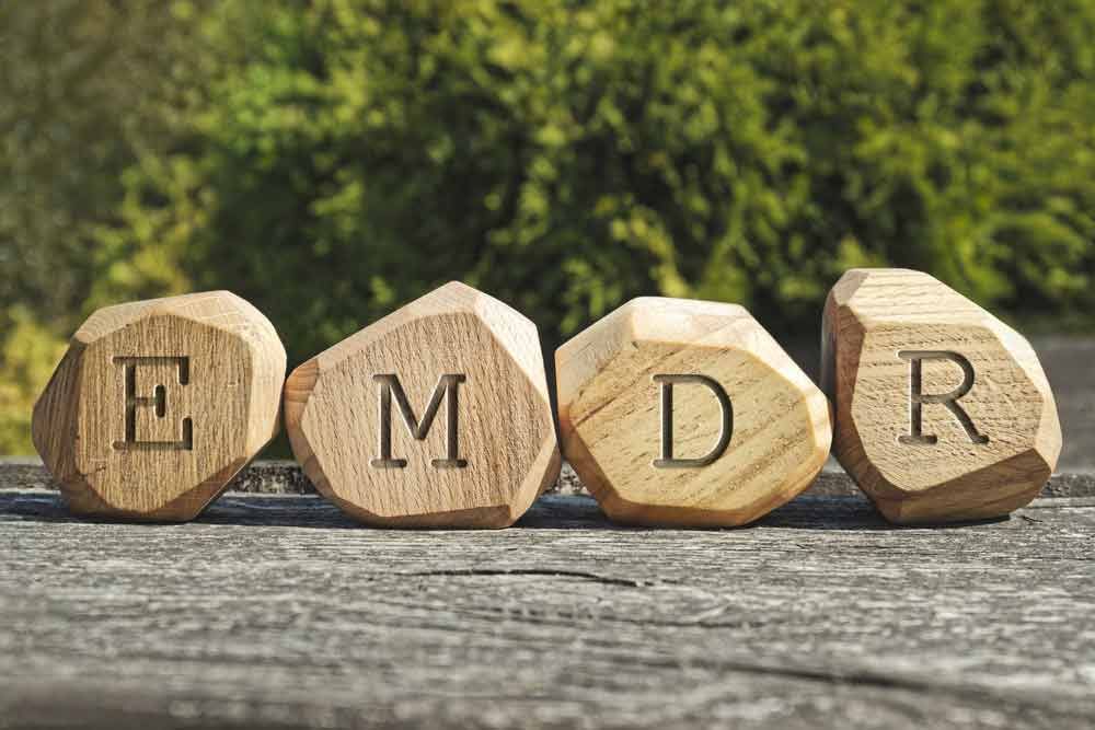 A row of wooden rocks with the word emdr written on them.