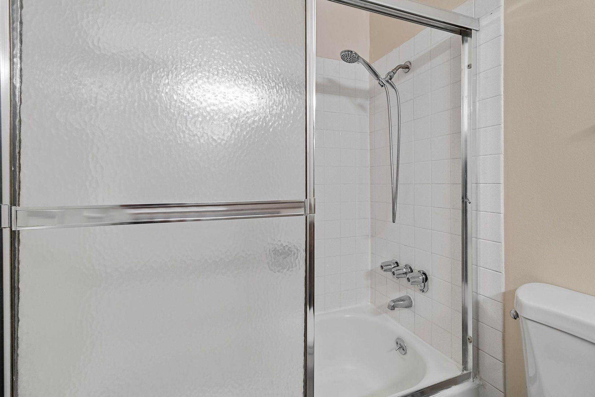 A bathroom featuring a wooden vanity with a granite countertop, a mirror, a sink, a toilet, and a towel bar at Parkview Apartments.