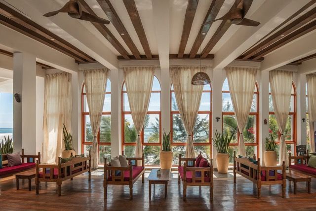 A large room with a lot of furniture and a ceiling fan.