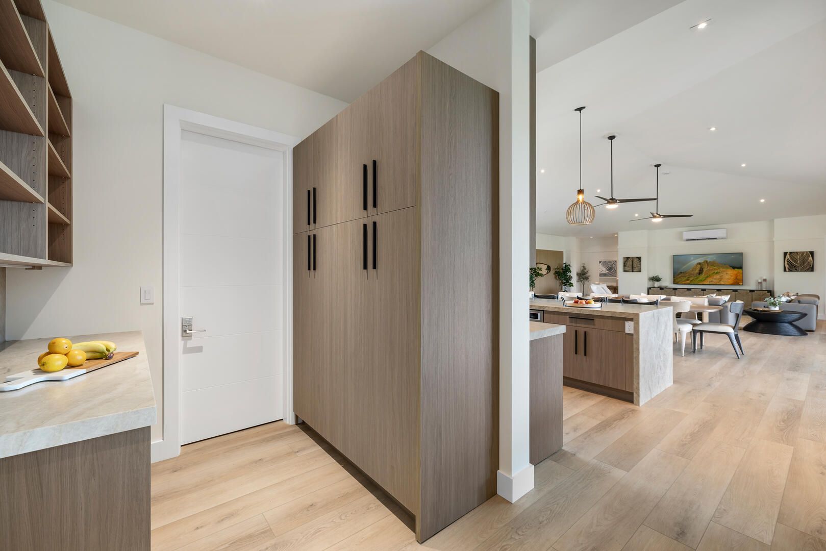 A kitchen with wooden cabinets and hardwood floors