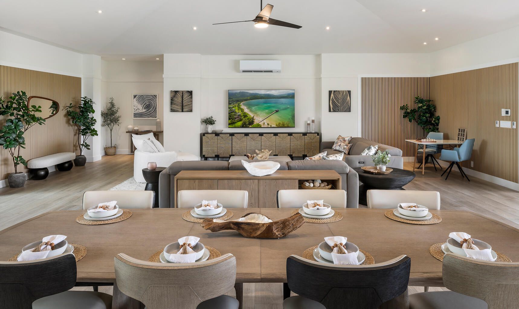 A large living room with a dining table and chairs