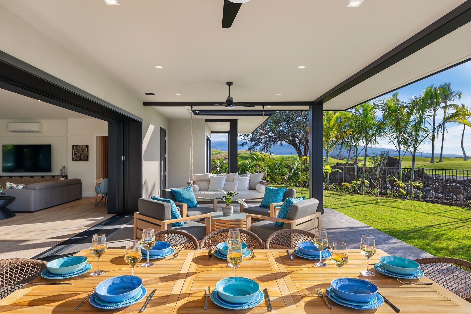 A patio with a table and chairs and a ceiling fan.