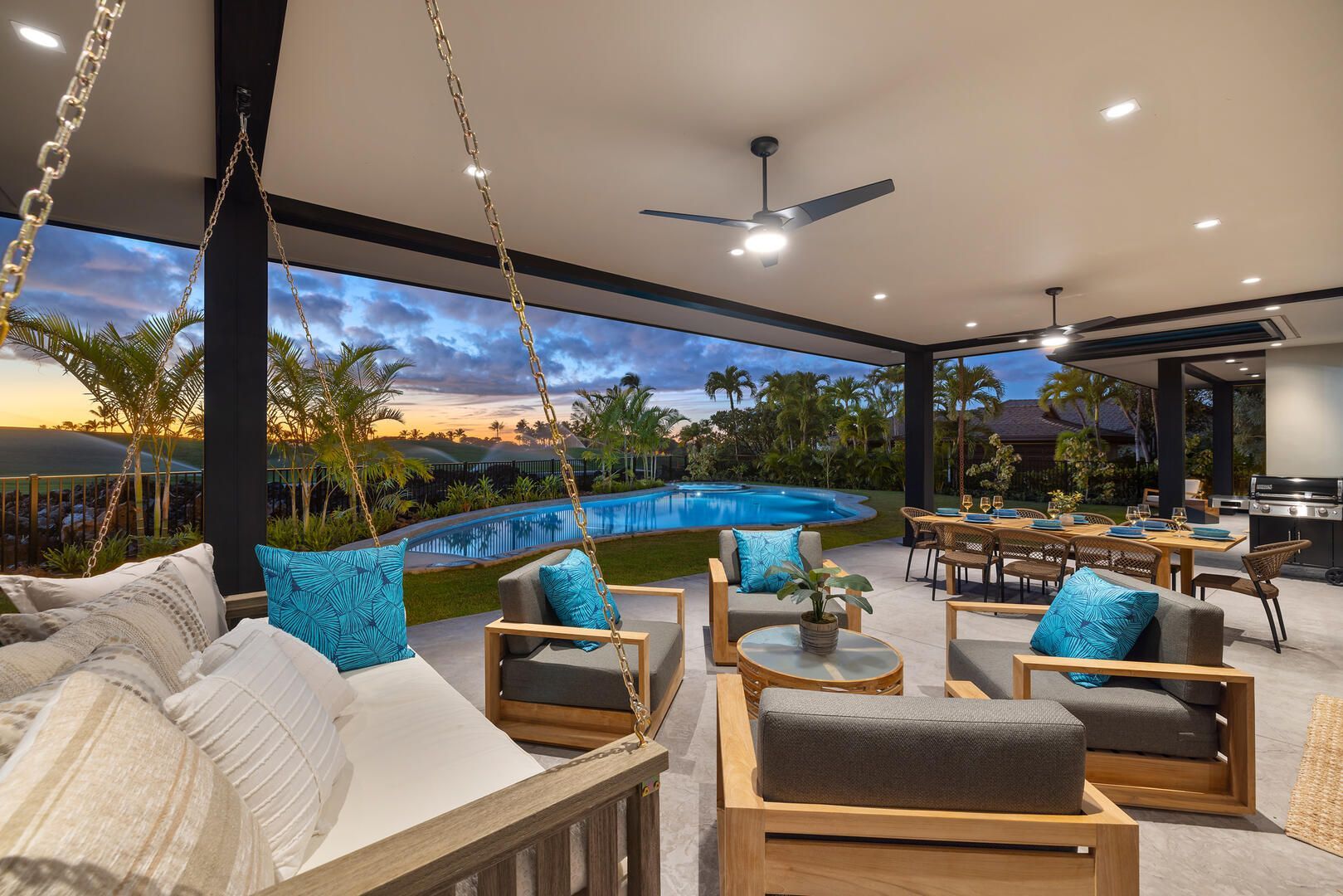 A patio with chairs , tables and a ceiling fan