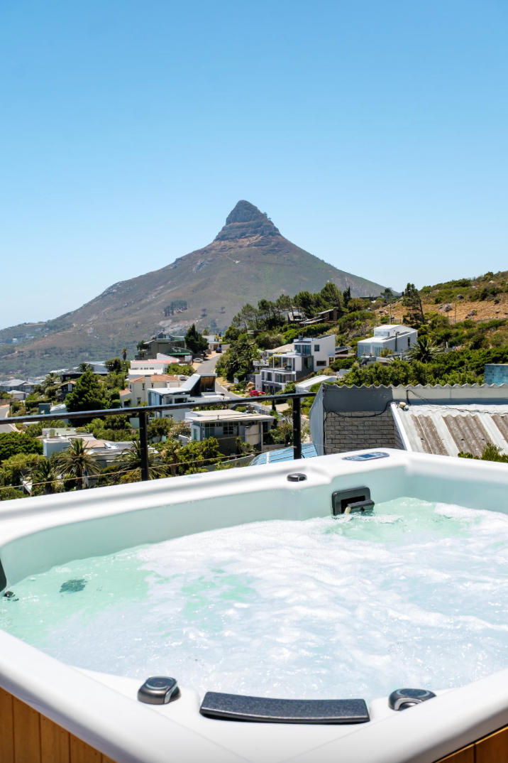 Hot tub overlooking Lion's Head mountain in Cape Town, South Africa, on a sunny day.