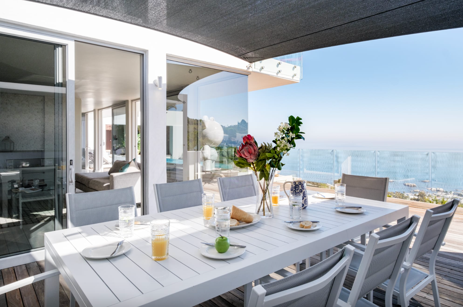 Outdoor dining table set for brunch with ocean view.