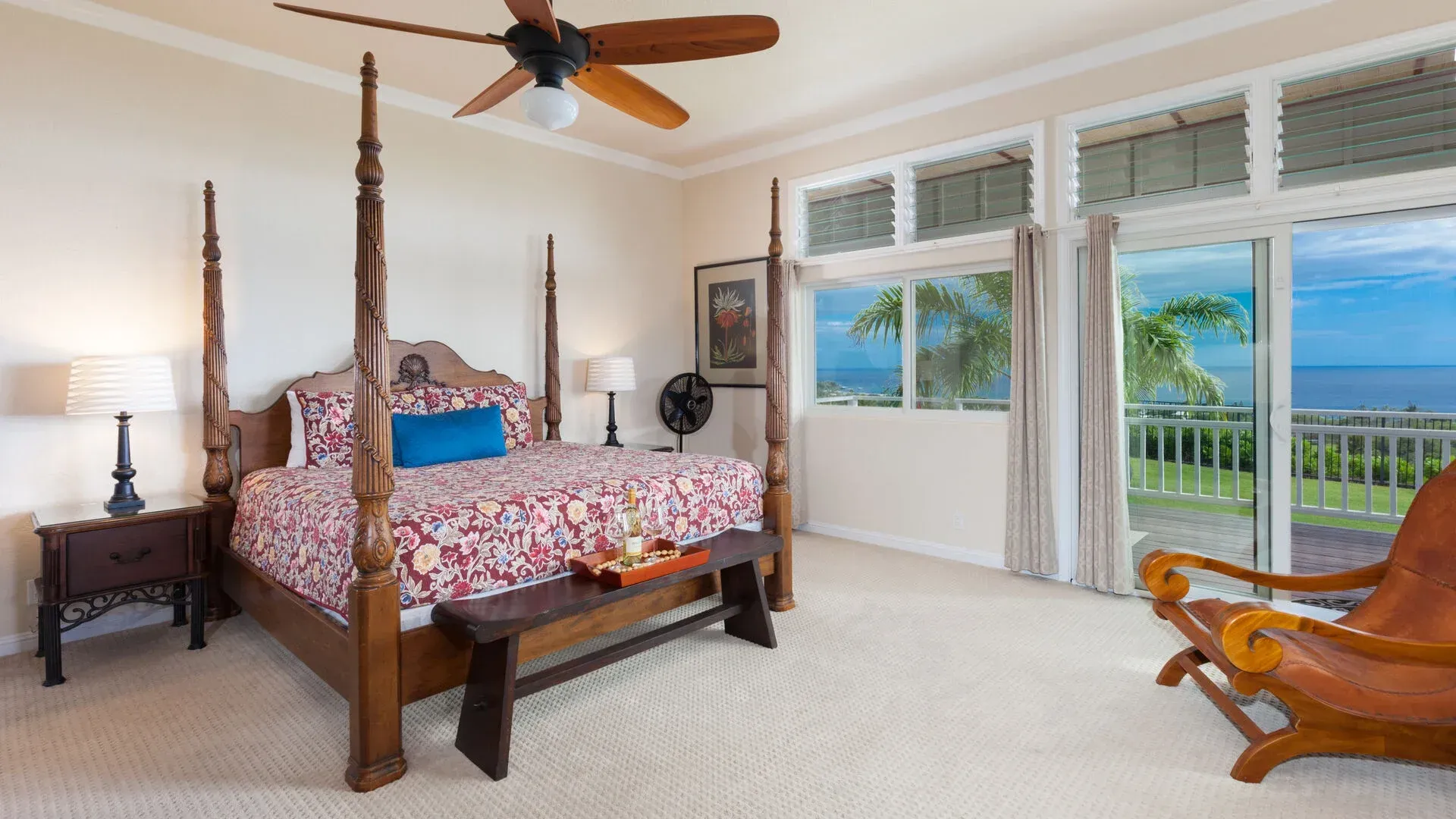 A bedroom with a four poster bed and a ceiling fan.