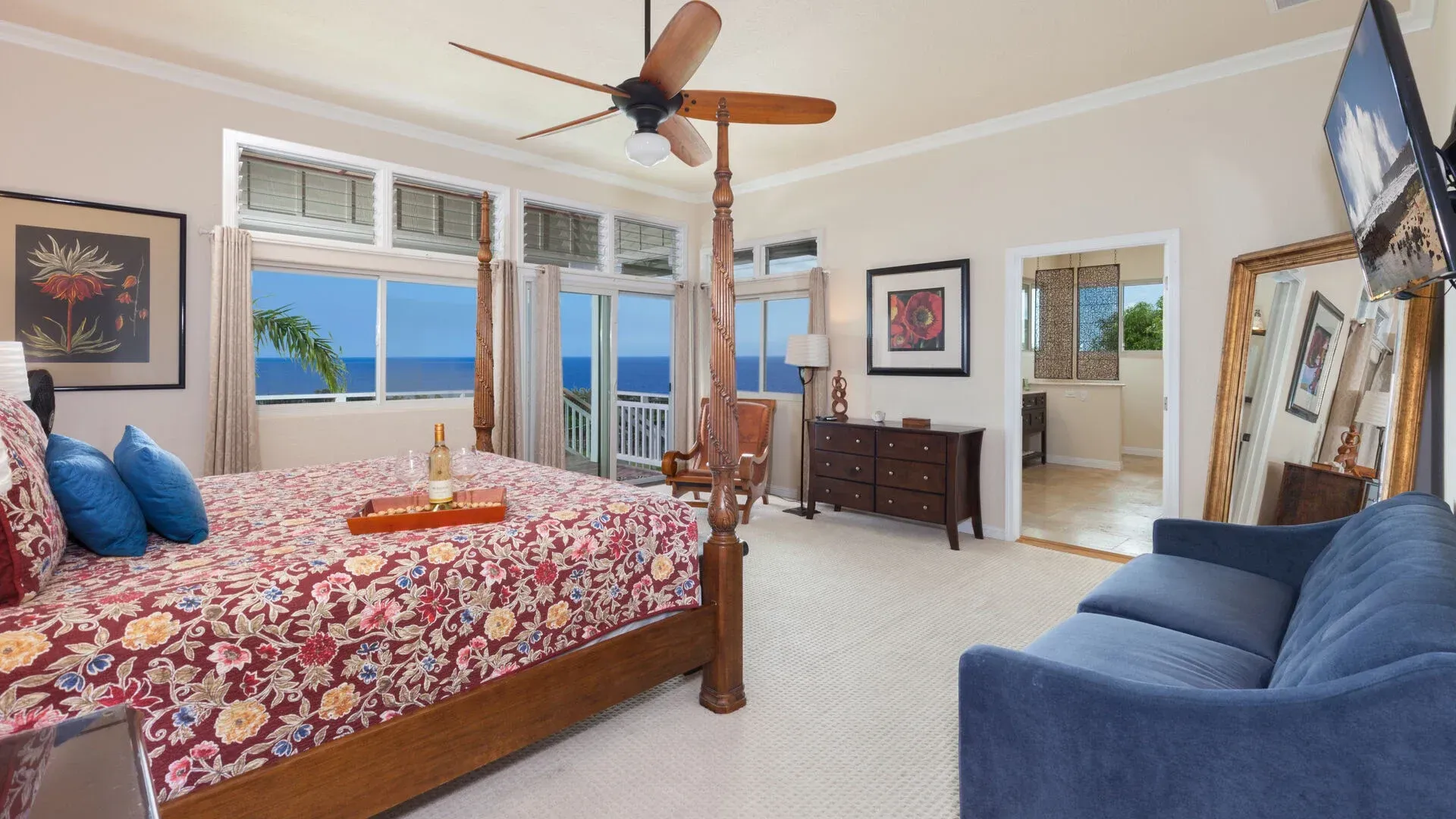 A bedroom with a four poster bed and a blue couch