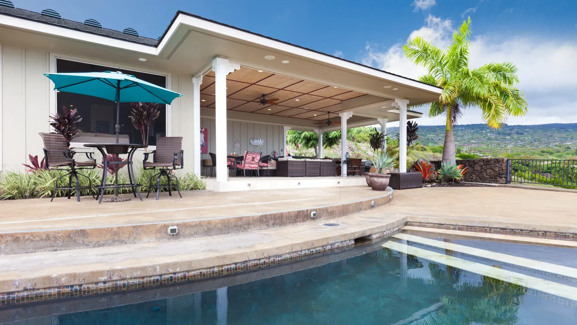A large house with a swimming pool in front of it.
