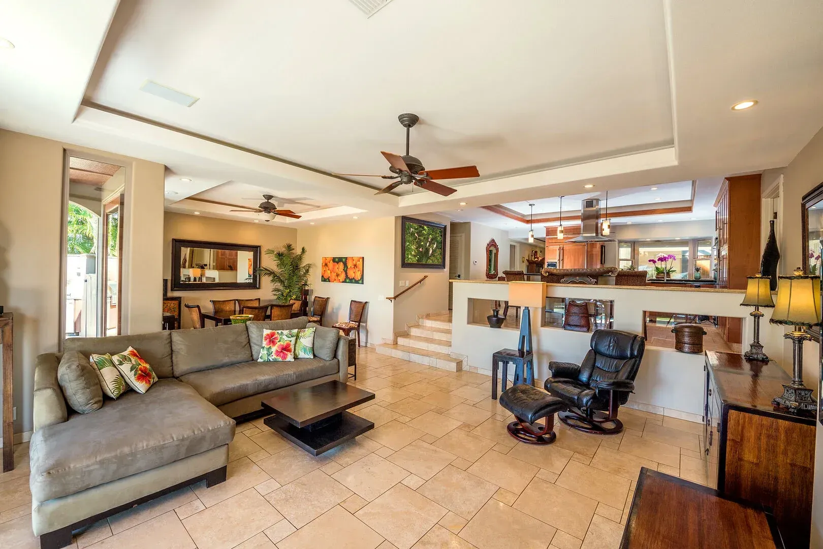 A living room filled with furniture and a ceiling fan.