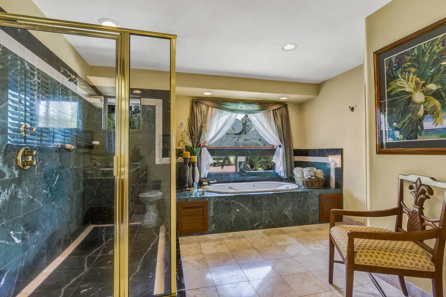 Luxurious bathroom with marble and gold accents; shower, tub, and chair.