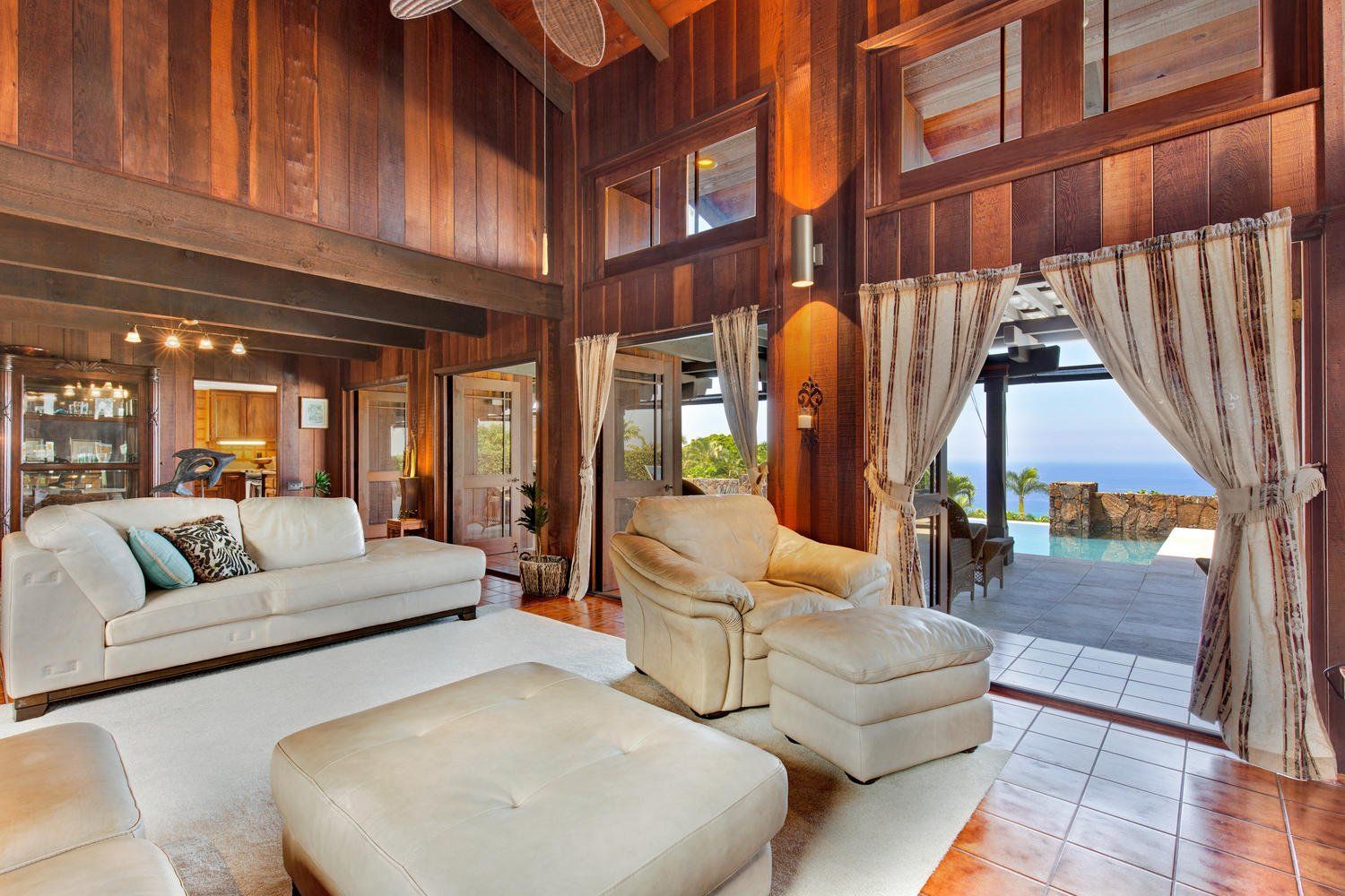 A living room with a couch , chair and ottoman