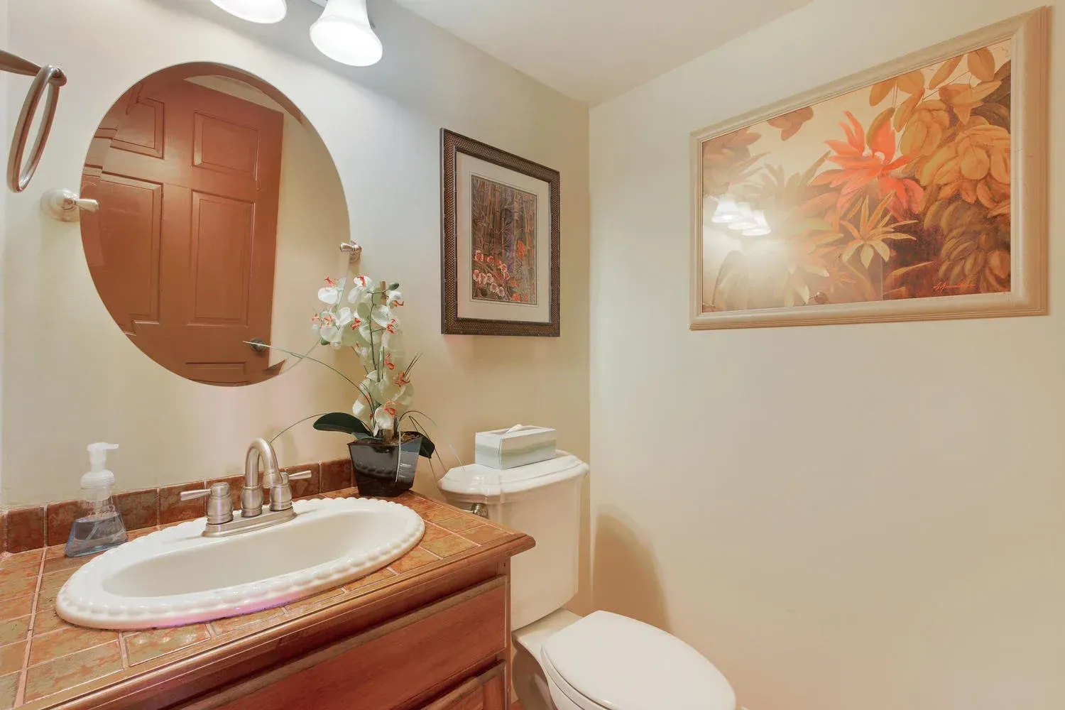 A bathroom with a sink , toilet and mirror.