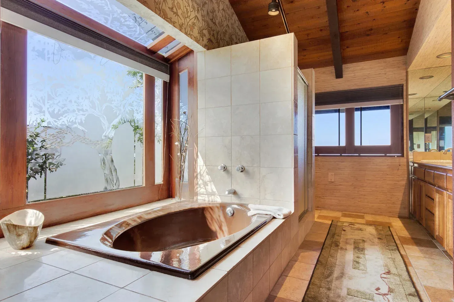 A bathroom with a large tub and a window