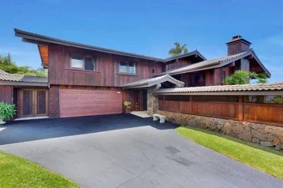 A large wooden house with a red garage door