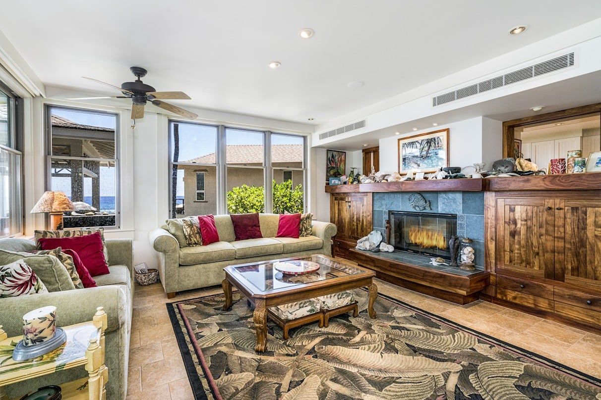 A living room filled with furniture and a fireplace.