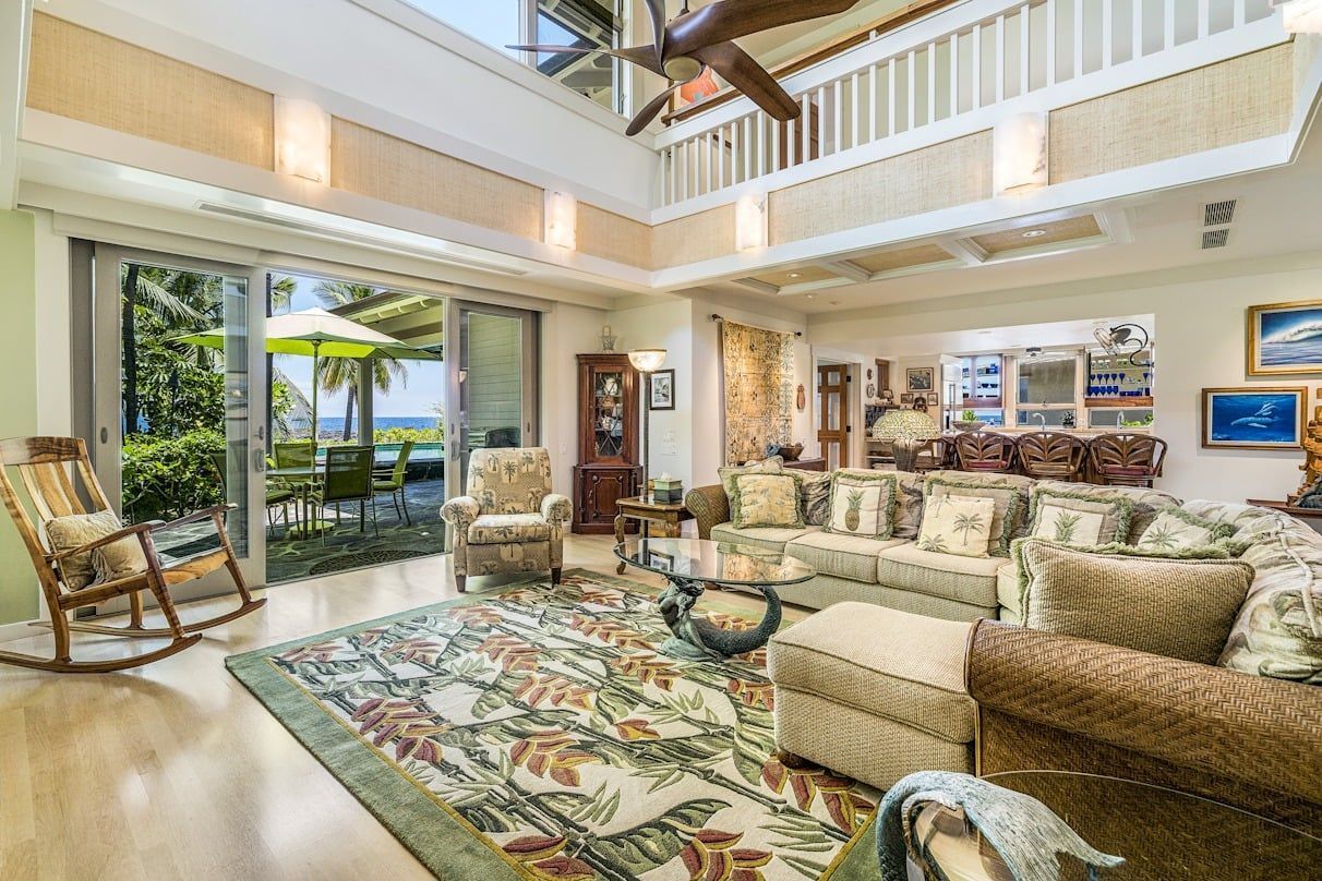 A living room filled with furniture and a ceiling fan.