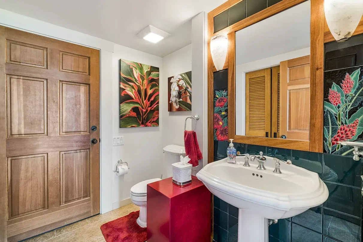 A bathroom with a sink , toilet , and mirror.