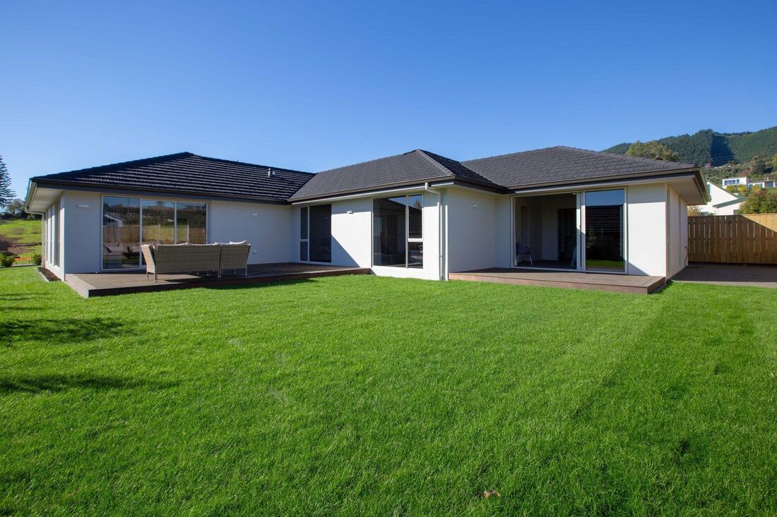 A house with a large lawn in front of it.