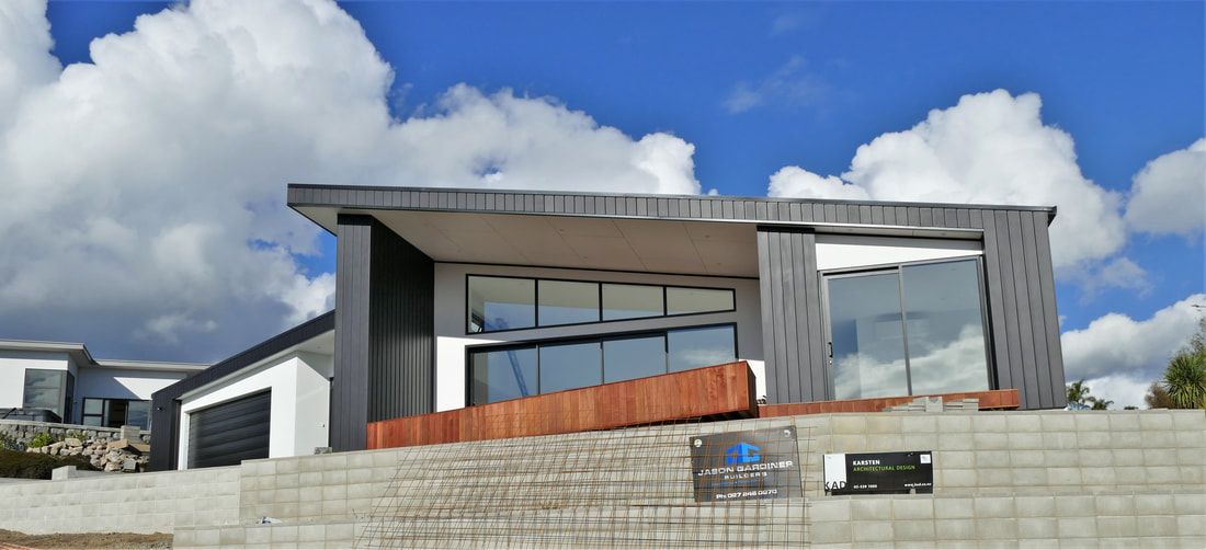 A large house is sitting on top of a hill.