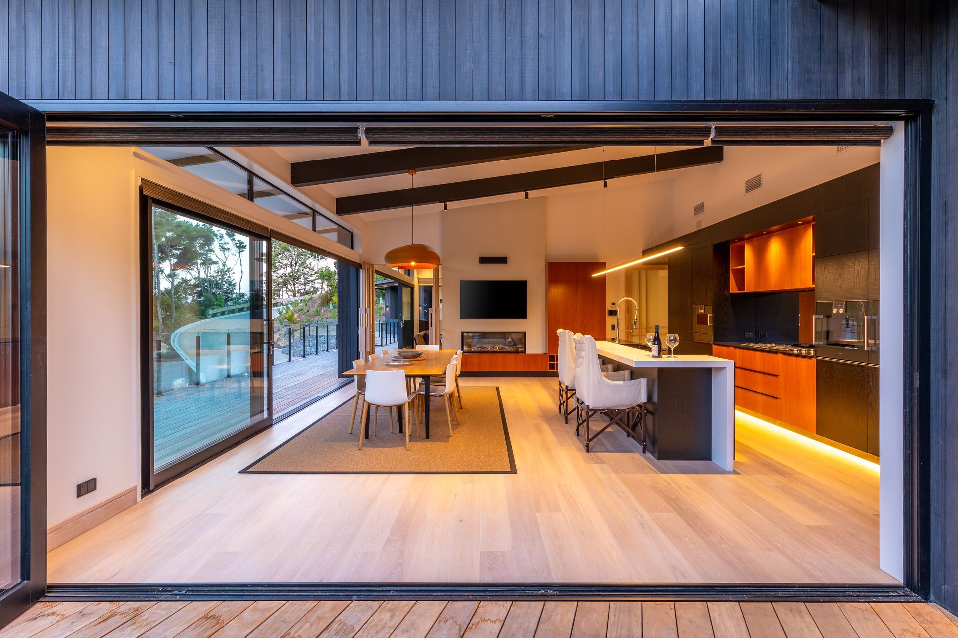 A kitchen and dining room in a house with sliding glass doors.
