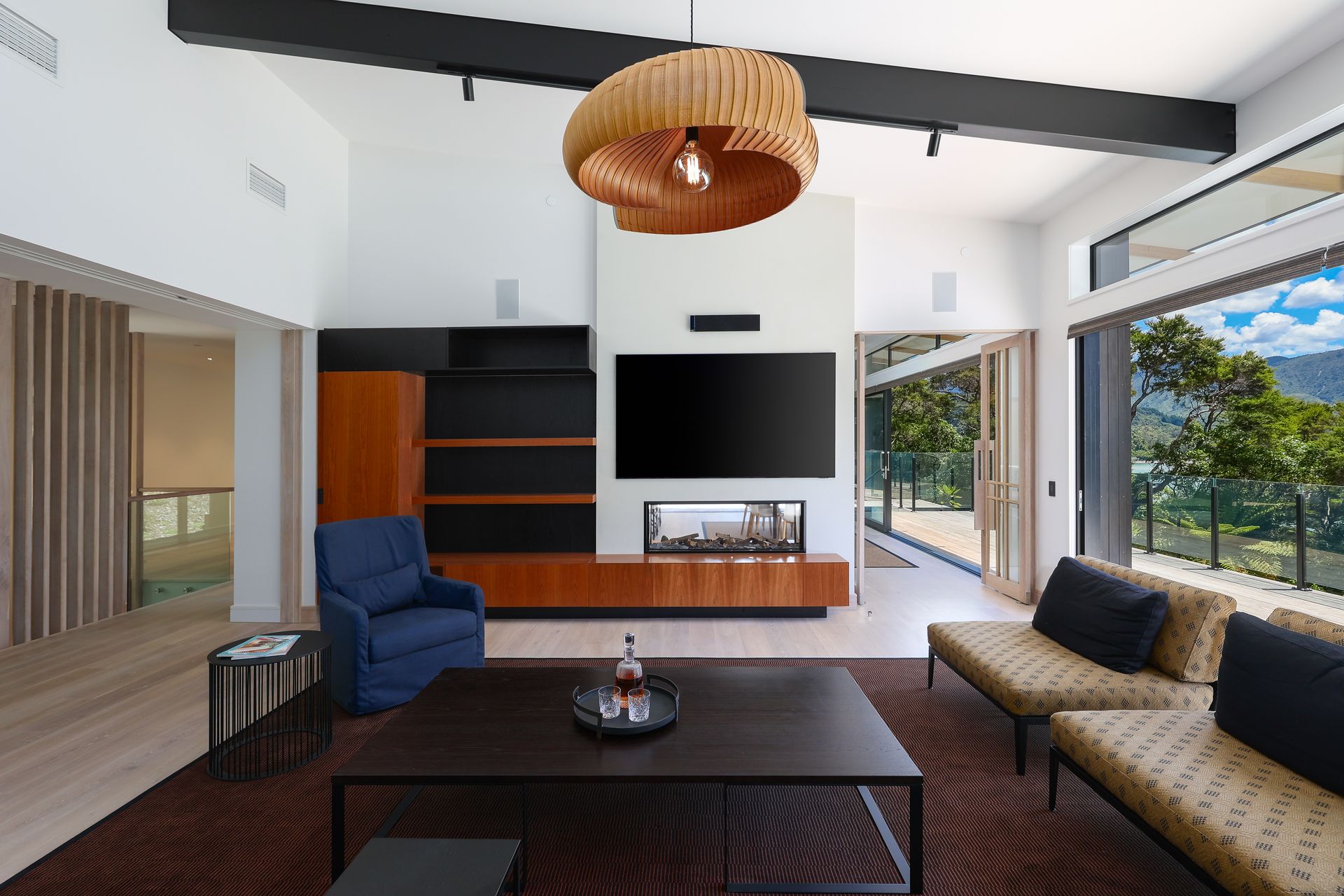 A living room with a couch , chair , coffee table and television.