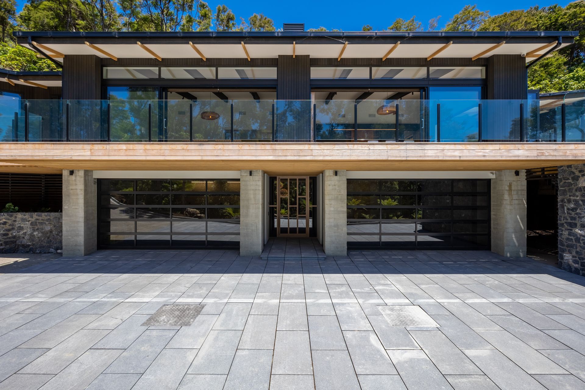 A large house with a lot of windows and a large driveway