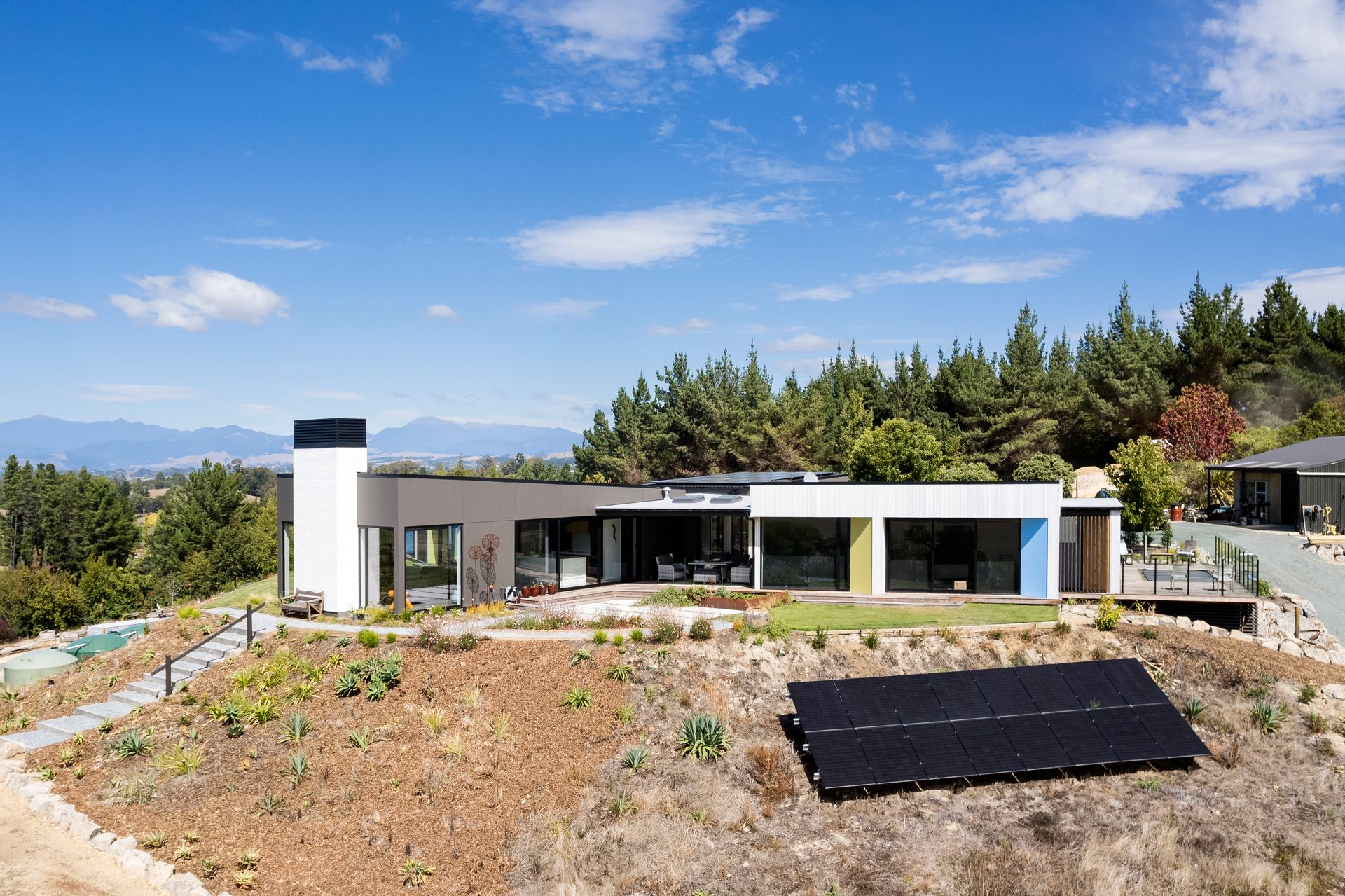 A house with a solar panel in front of it