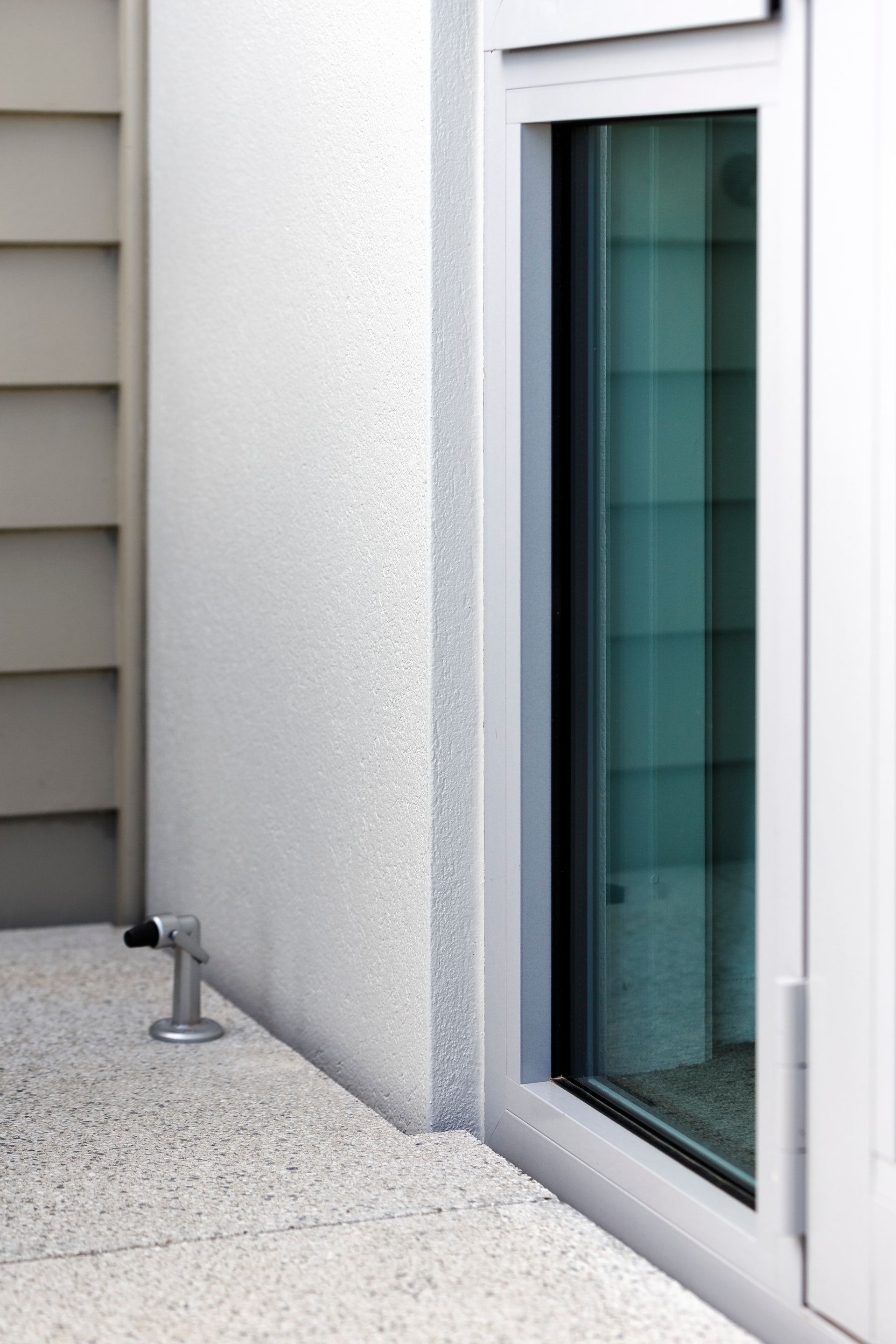 A white wall with a window on the side of it