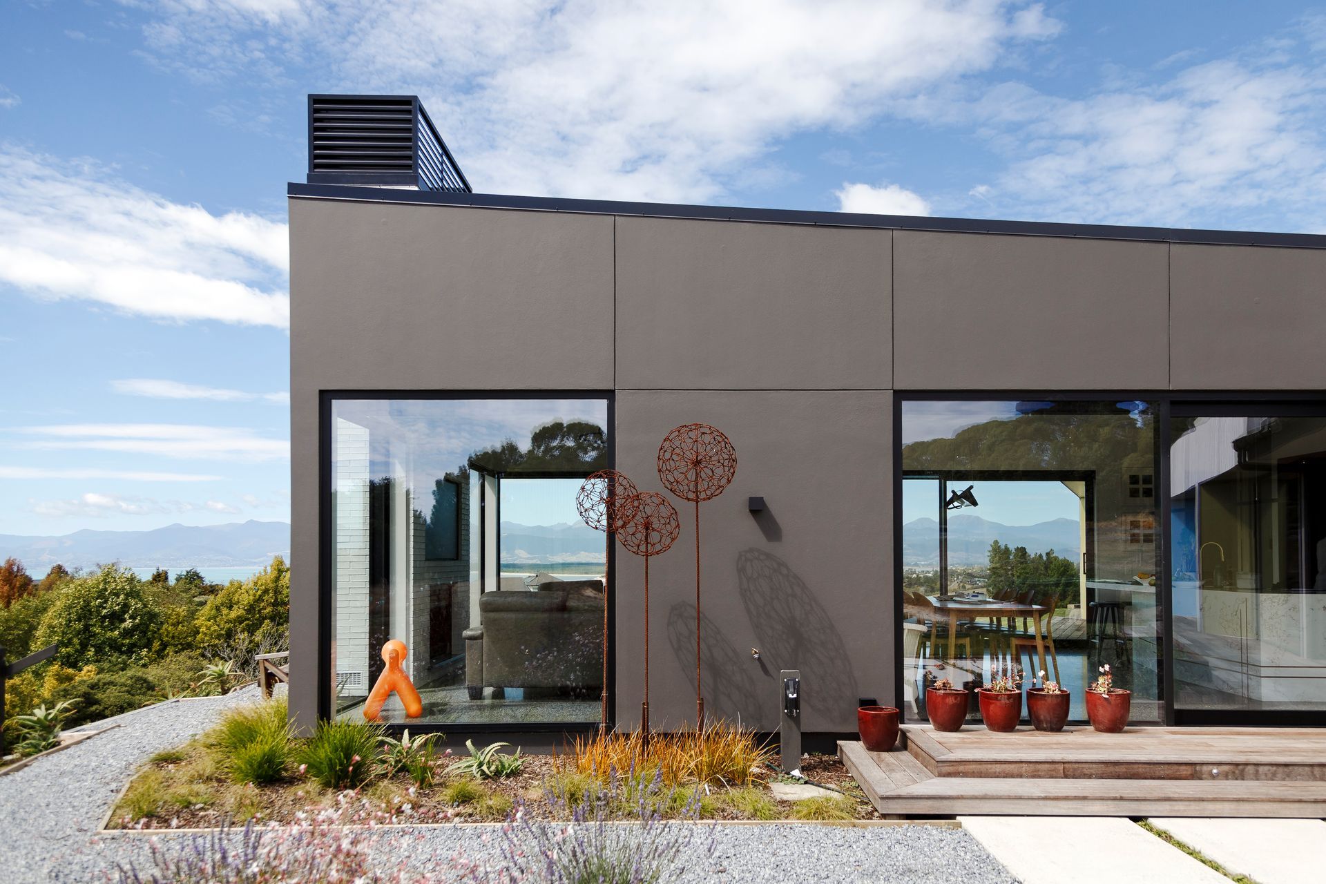 A house with a lot of windows and a clock on the side