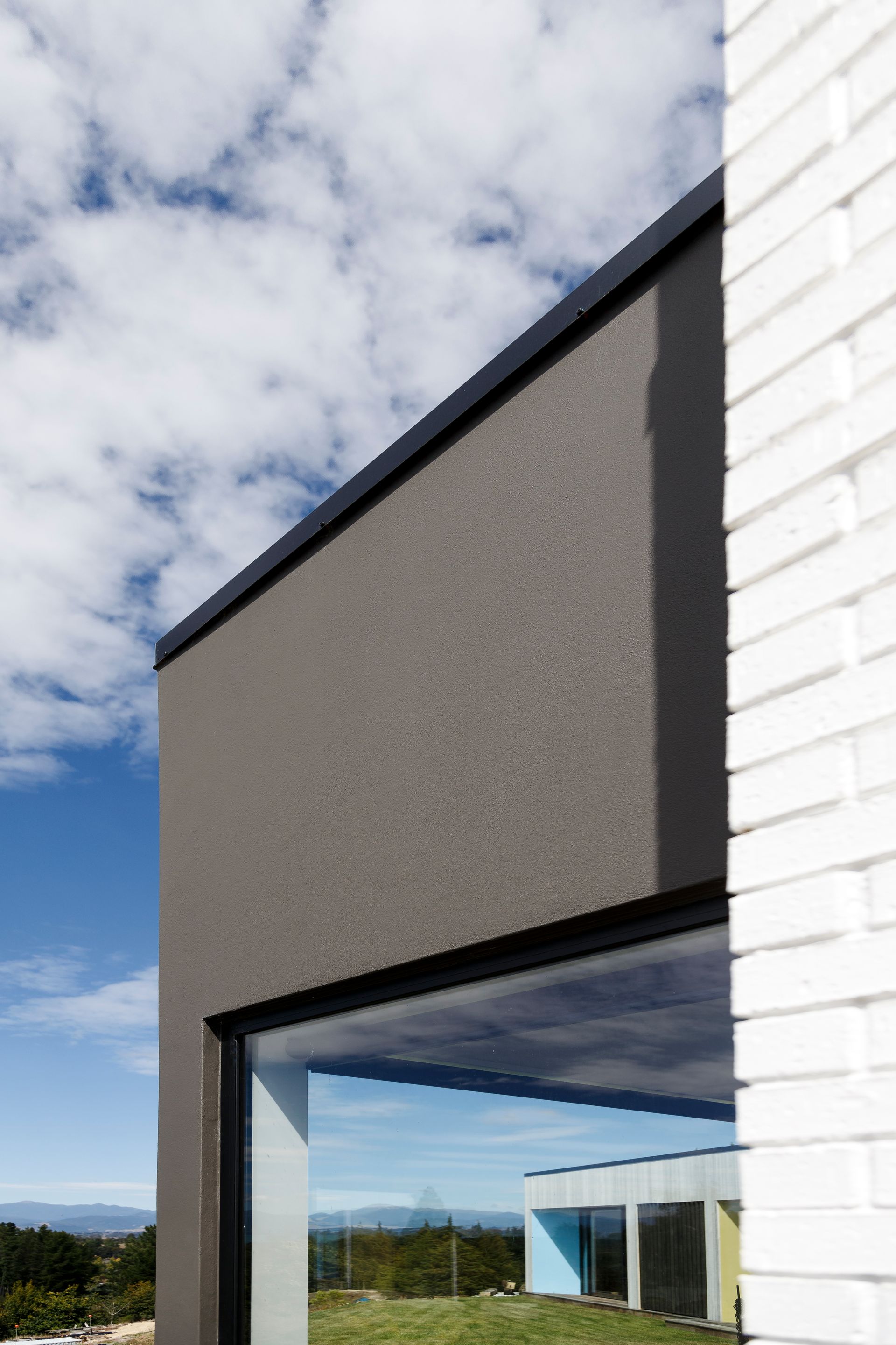 A building with a large window and a white brick wall