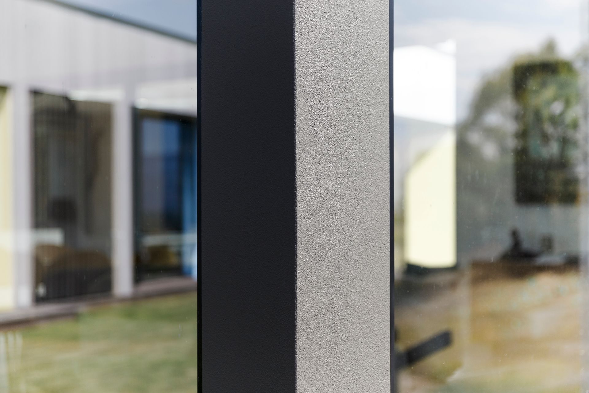 A close up of a window with a house in the background.